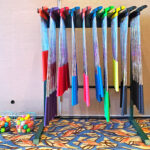 Free standing rack with selection of golf clubs for rent from Arcade Party Rental