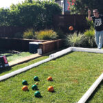 Mini bocce ball court set up in backyard on the grass Arcade Party Rental